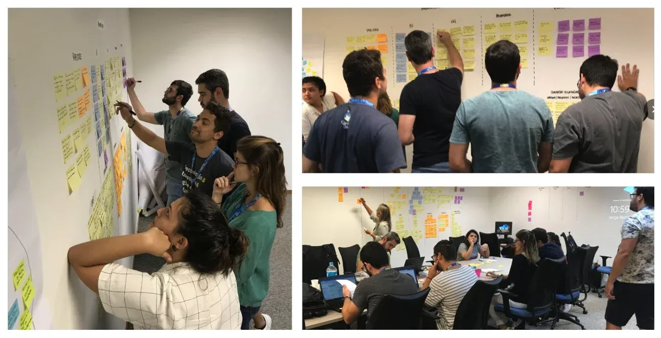 Trainees da Ipiranga trabalhando nas paredes cobertas de post-its